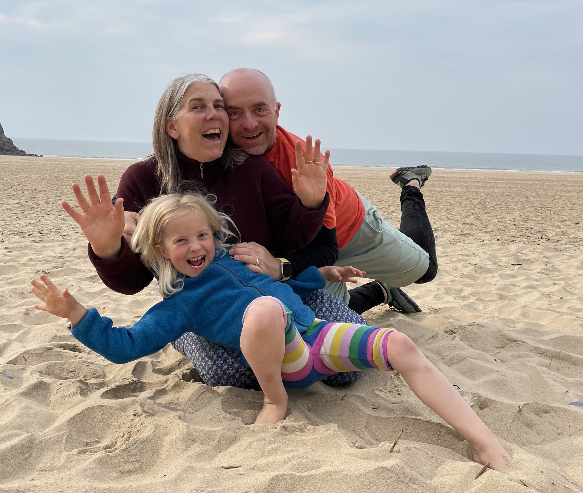 Carl and family laughing together on a West Country beach